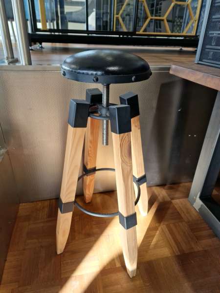 Bar stool made of steel, wood and upholstered seat